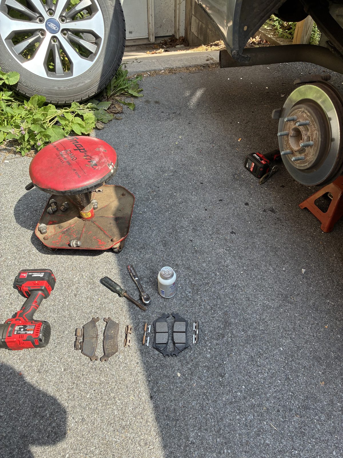 Worn, rusted rear brake rotor and hub before replacement