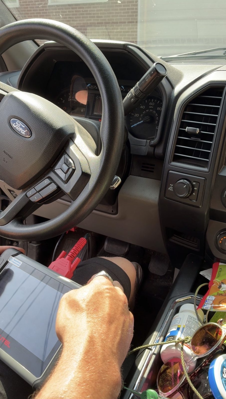 Scan tool plugged into a vehicle's diagnostic port reading trouble codes